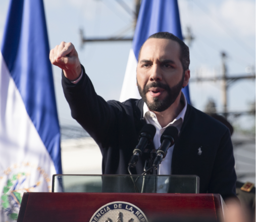 Nayib Bukele pointing at a podium