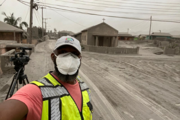 Kenton Chance reporting in front of street covered in ash