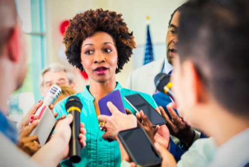 Person speaking to reporters