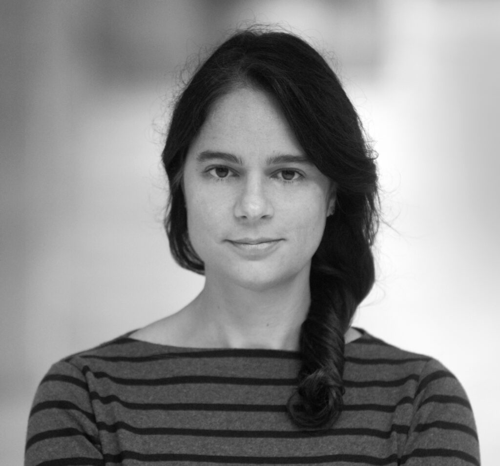 latino woman with long brown hair looking at the camera