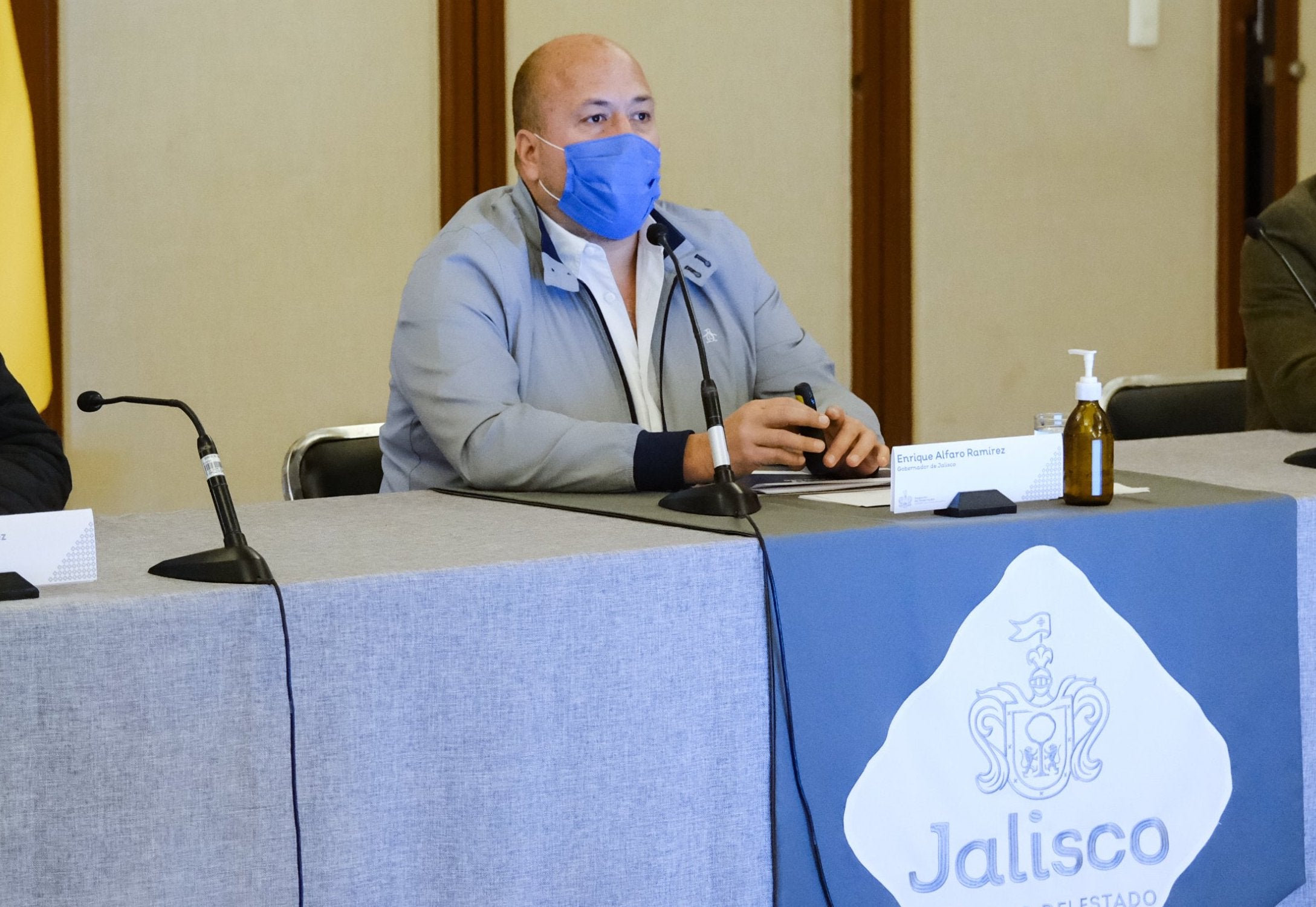 Man in a mask sitting at a table