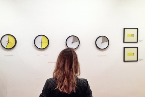 Woman looking at graph charts in art gallery.