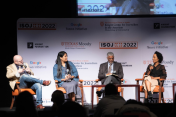 Four people on stage during a panel on ISOJ 2022