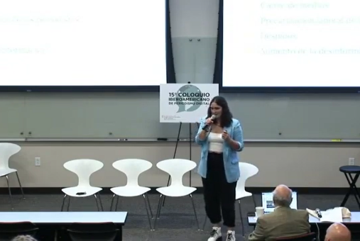 Woman in front of a screen doing a presentation