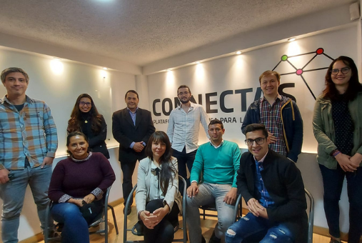 The team at CONNECTAS: two women and two men seated in front of two women and four men standing