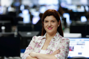 Journalist Katia Brembatti standing in a newsroom