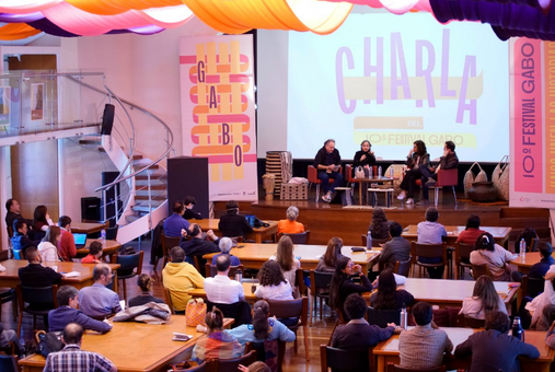 a group of people giving a speech in a conference