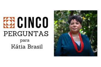 Woman standing among trees in the Amazon forest and looking at the camera