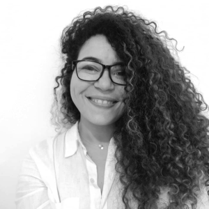 a woman with curly hair and smiling to the camara