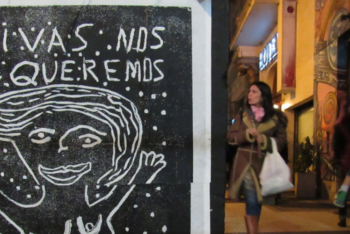 poster with a drawing and the sentence "vivas nos queremos" in a street in buenos aires