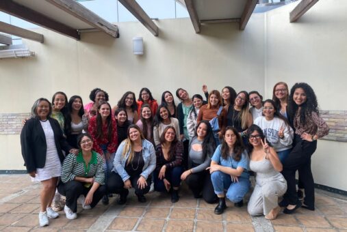 a group of women smiling to the camara