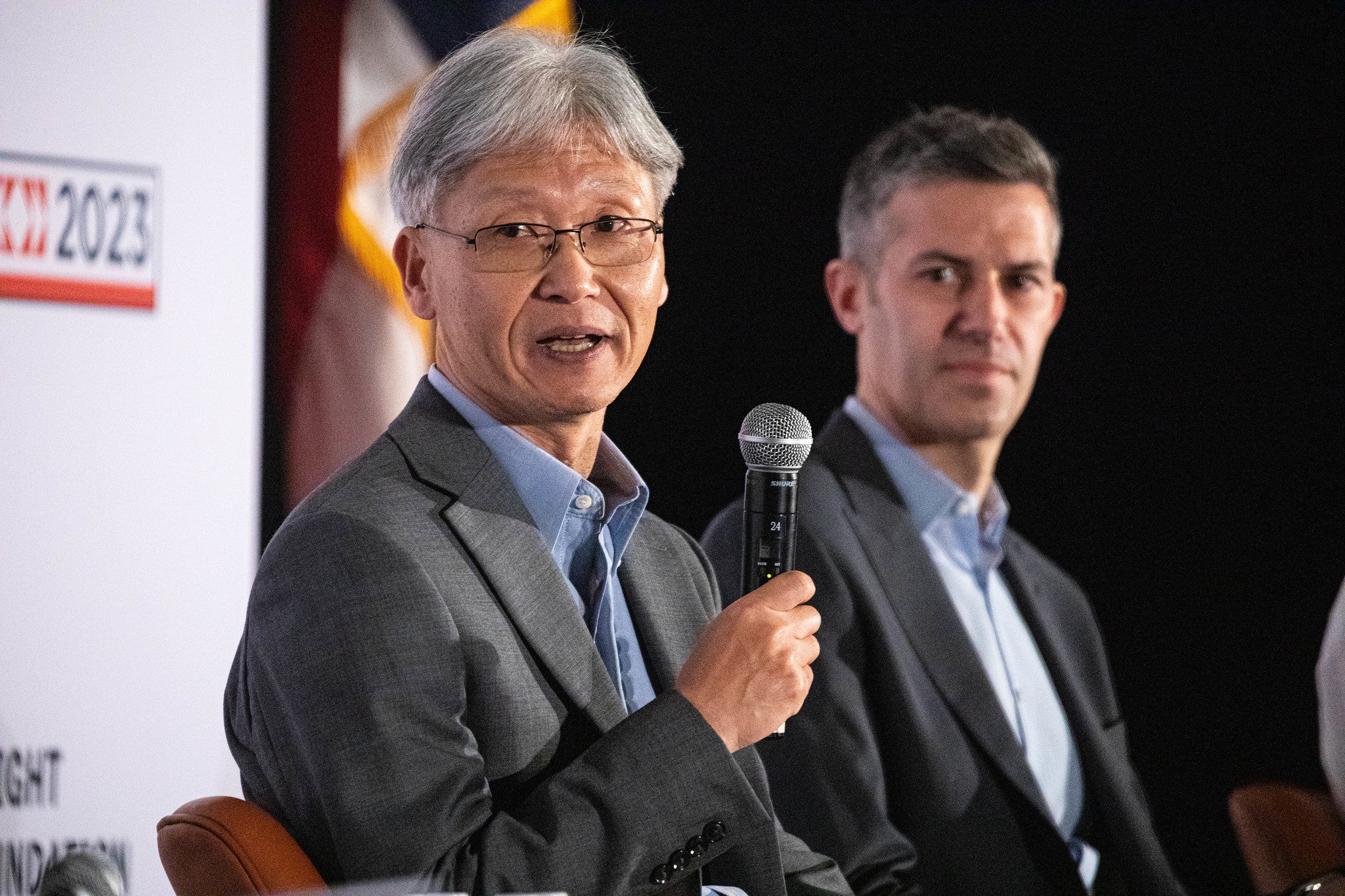 Two panelists discuss on the ISOJ stage, at UT Austin.