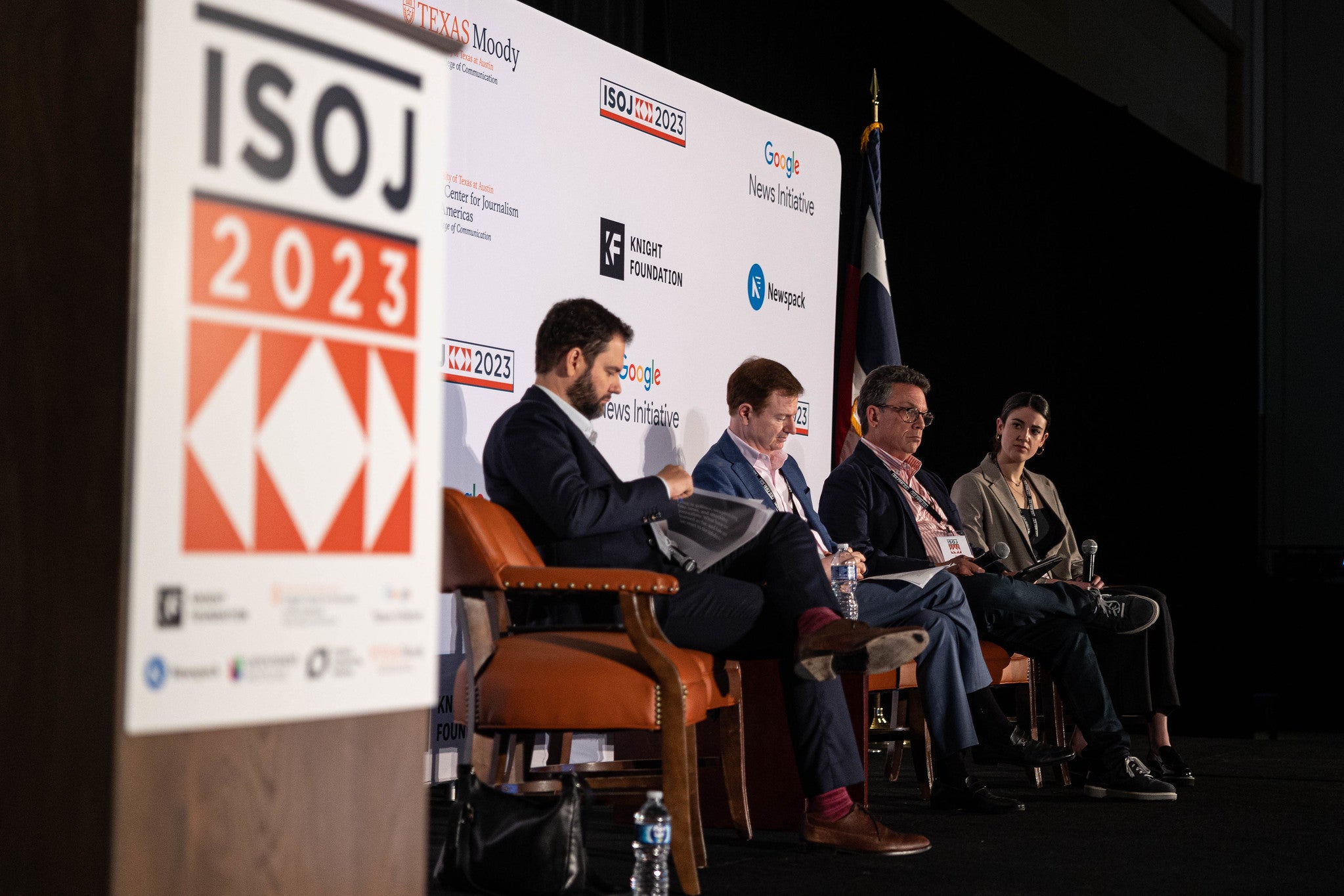 Four panelists discuss on the ISOJ stage, at UT Austin.