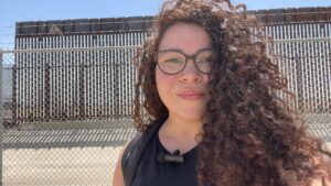 A woman with curly hair taking a selfie at El Paso, Texas
