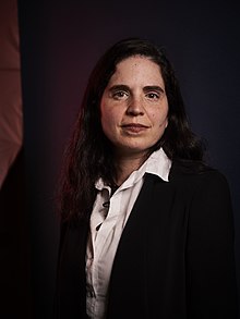 A picture of a woman agains a dark background