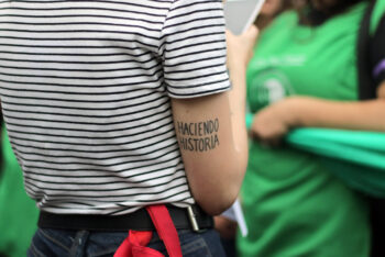 woman photographed from behind in feminist march