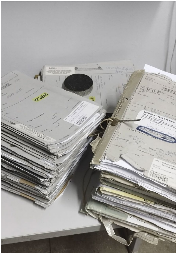 three piles of documents on a table