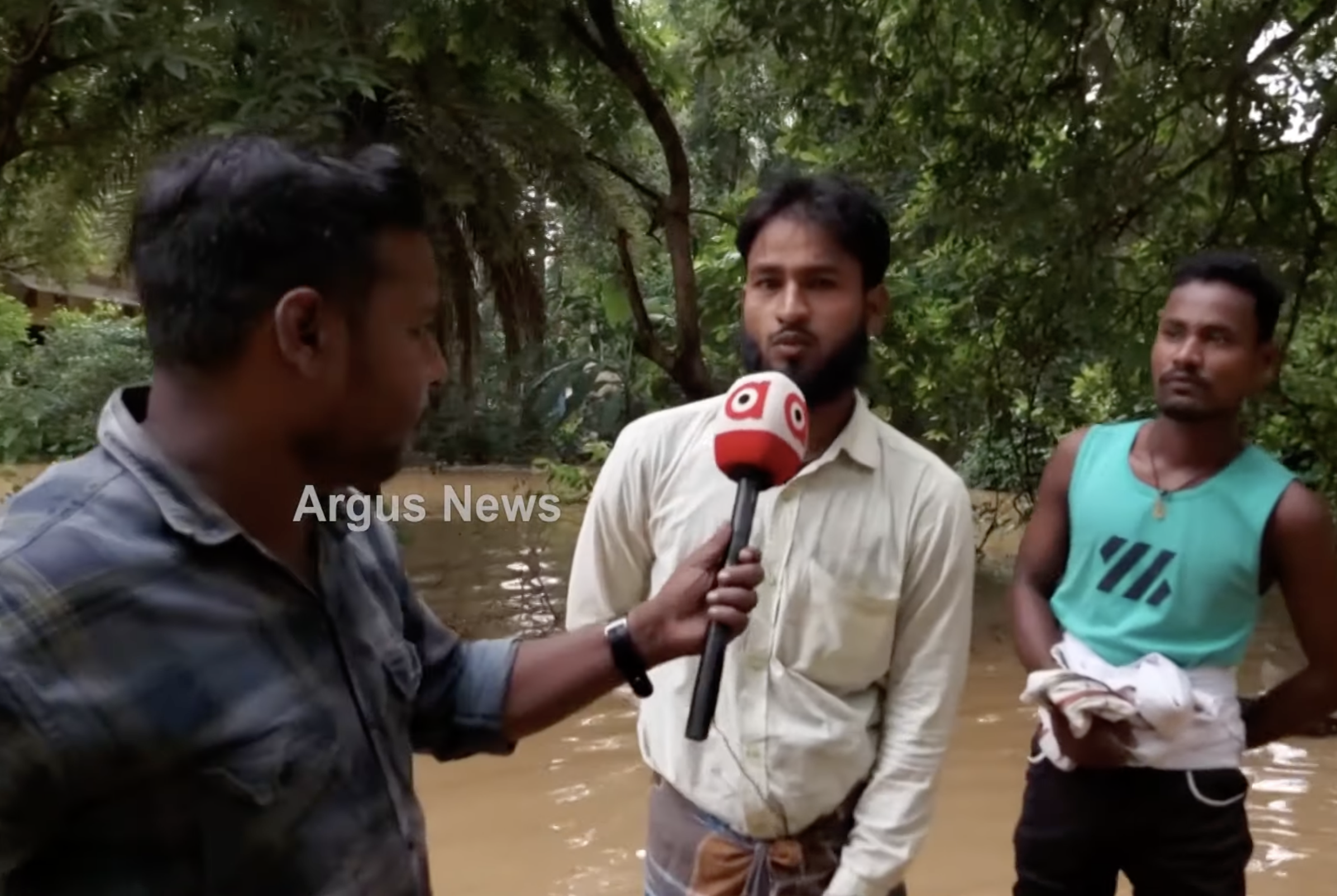 Reporter interviews residents of a region flooded by a natural disaster.