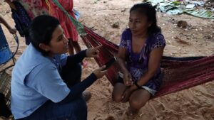 a journalist talking to an indigenous woman