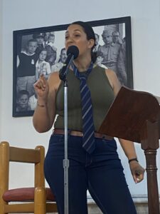 Woman wearing a tie standing at a podium