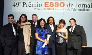 Seven people smiling with award
