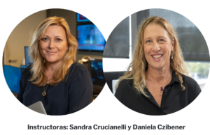 Two women with blonde hair and dark shirts smiling