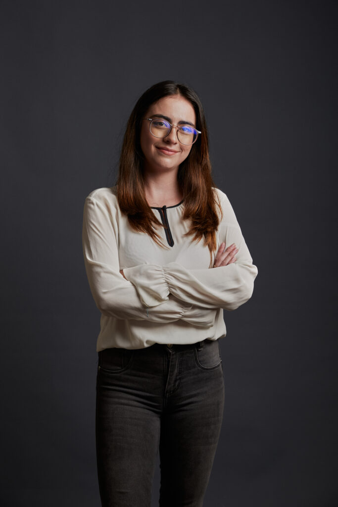 woman standing with crossed arms smiling at the camera