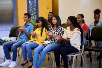 Participants of Cari-Bois' inaugural Youth Environmental Journalism Project listen attentively during the project's closing ceremony in October 2023.