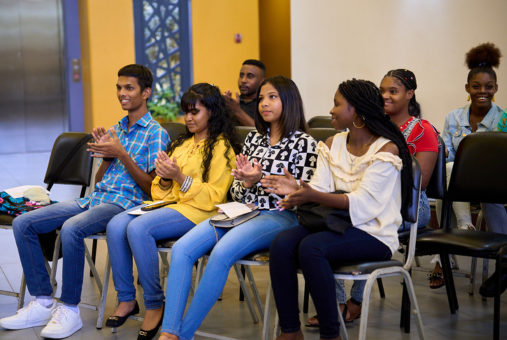 Participants of Cari-Bois' inaugural Youth Environmental Journalism Project listen attentively during the project's closing ceremony in October 2023.