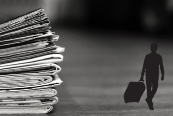 silhouette of a man with a suitcase. Newspapers in the background