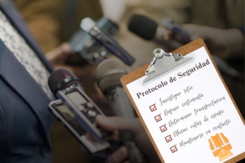 A checklist on a board with a background of microphones and voice recorders during reporters interviews to a man.