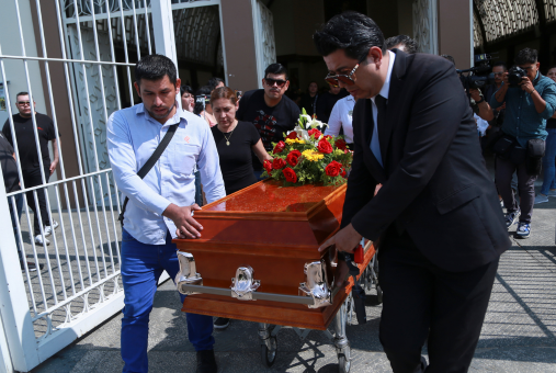 Group of people carry a coffin