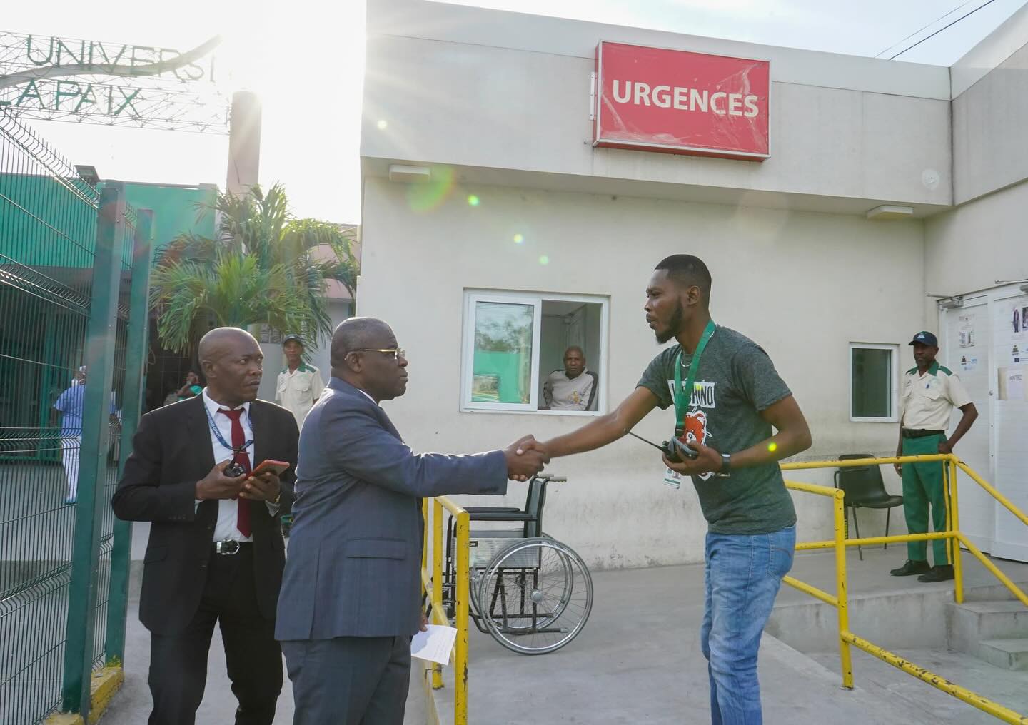 Government officials greet an employee at the entrance of a hospital in Haiti.