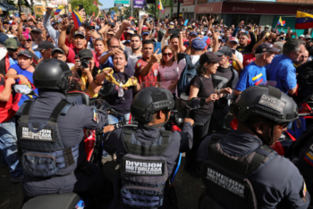 Crowd facing police officers