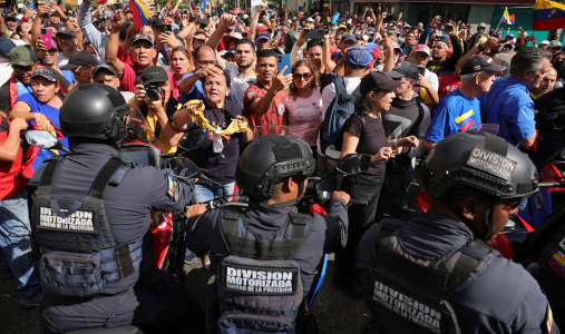 Crowd facing police officers