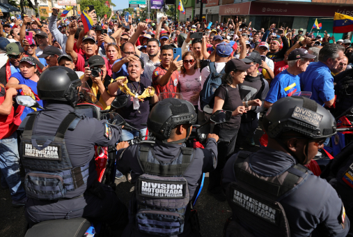 Crowd facing police officers