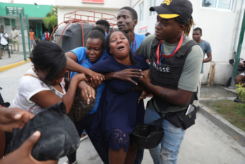 Woman crying being held by companions