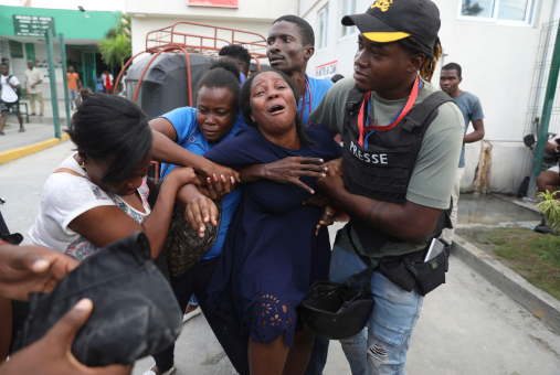 Woman crying being held by companions