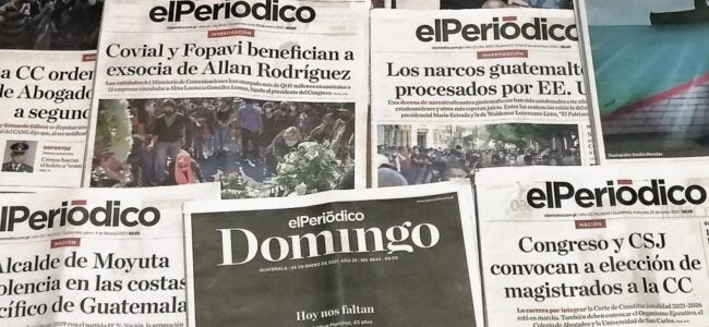 Printed editions of the Guatemalan newspaper elPeriódico spread out on a surface, featuring headlines on corruption, drug trafficking, and politics. A special Sunday edition stands out, paying tribute to journalists and figures who have been persecuted or exiled.