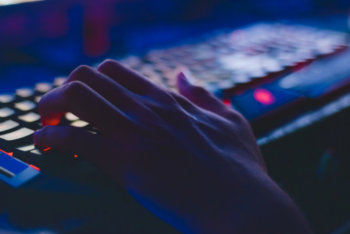 Photo of person typing on computer keyboard.