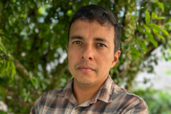 Man in front of trees