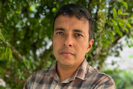 Man in front of trees