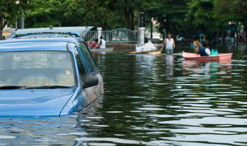 People navigating flooded streets in canoes