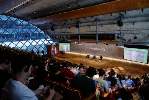 Audience at GlobalFact 12 watches Brazilian Supreme Court justices Cármen Lúcia (left screen) and Alexandre de Moraes (right screen) speak remotely during the opening panel in Rio de Janeiro