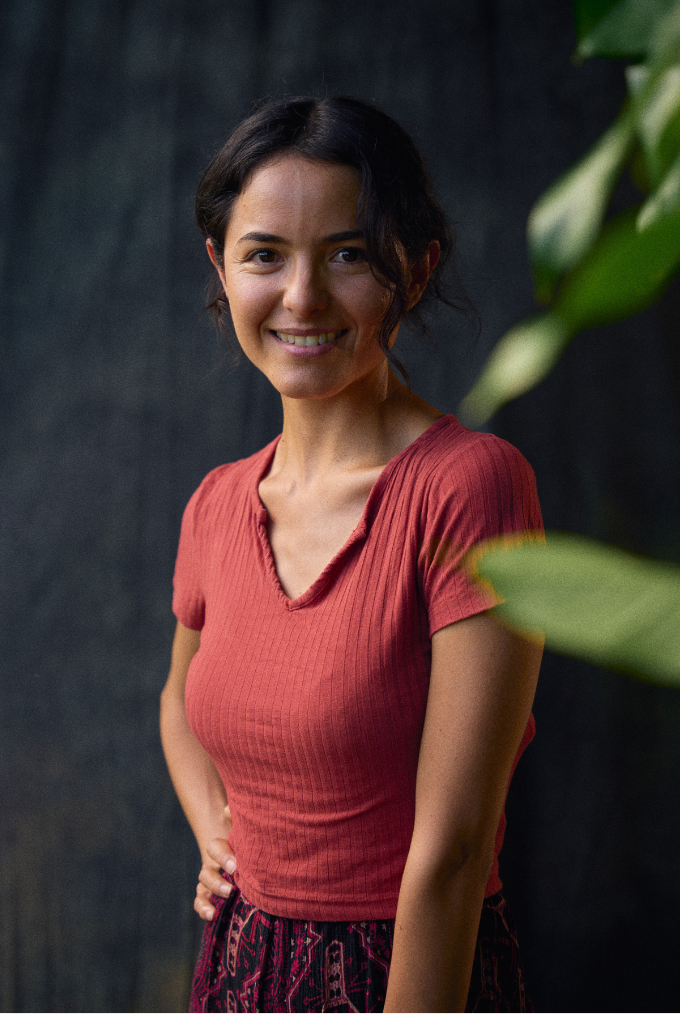 Ecuadoran journalist Ana Cristina Alvarado poses in front of a dark background.