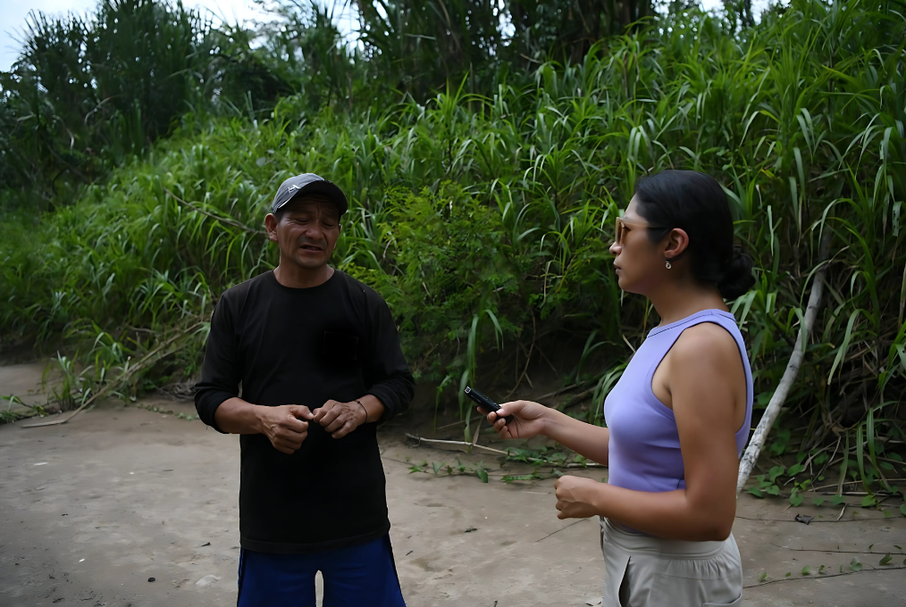 Peruvian journalist Elizabeth Salazar interviews a man in the Amazon rainforest.