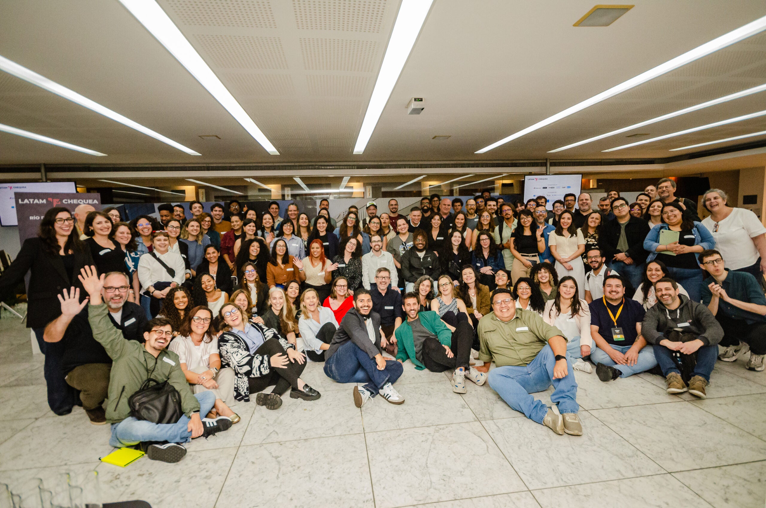 Large group of people looking and smiling to the camera