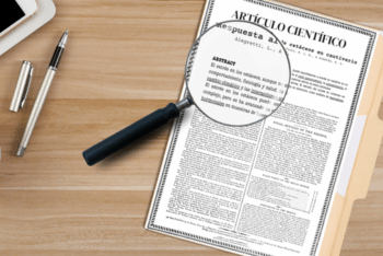 A scientific paper in a folder, on a table with a magnifier glass above.