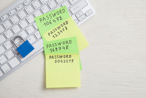 Password message written on sticky notes. Padlock on the keyboard. Password security