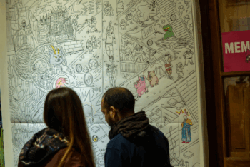two people looking at a mural